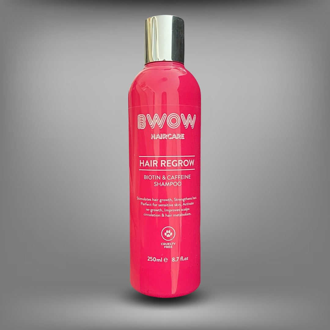 Pink bottle of BWOW Hair Regrow Biotin & Caffeine Shampoo with a silver cap, designed to stimulate hair growth and strengthen hair.