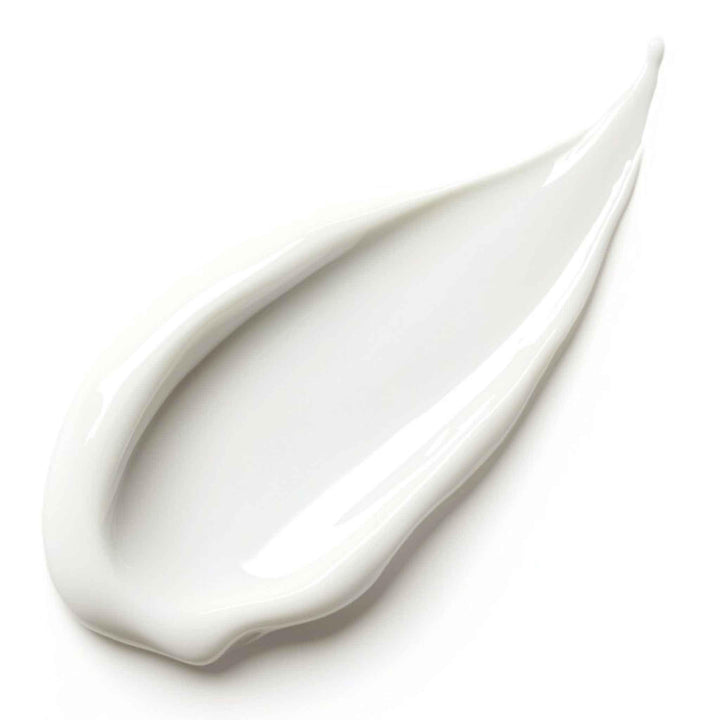 Close-up of a white cream smear on a light gray background
