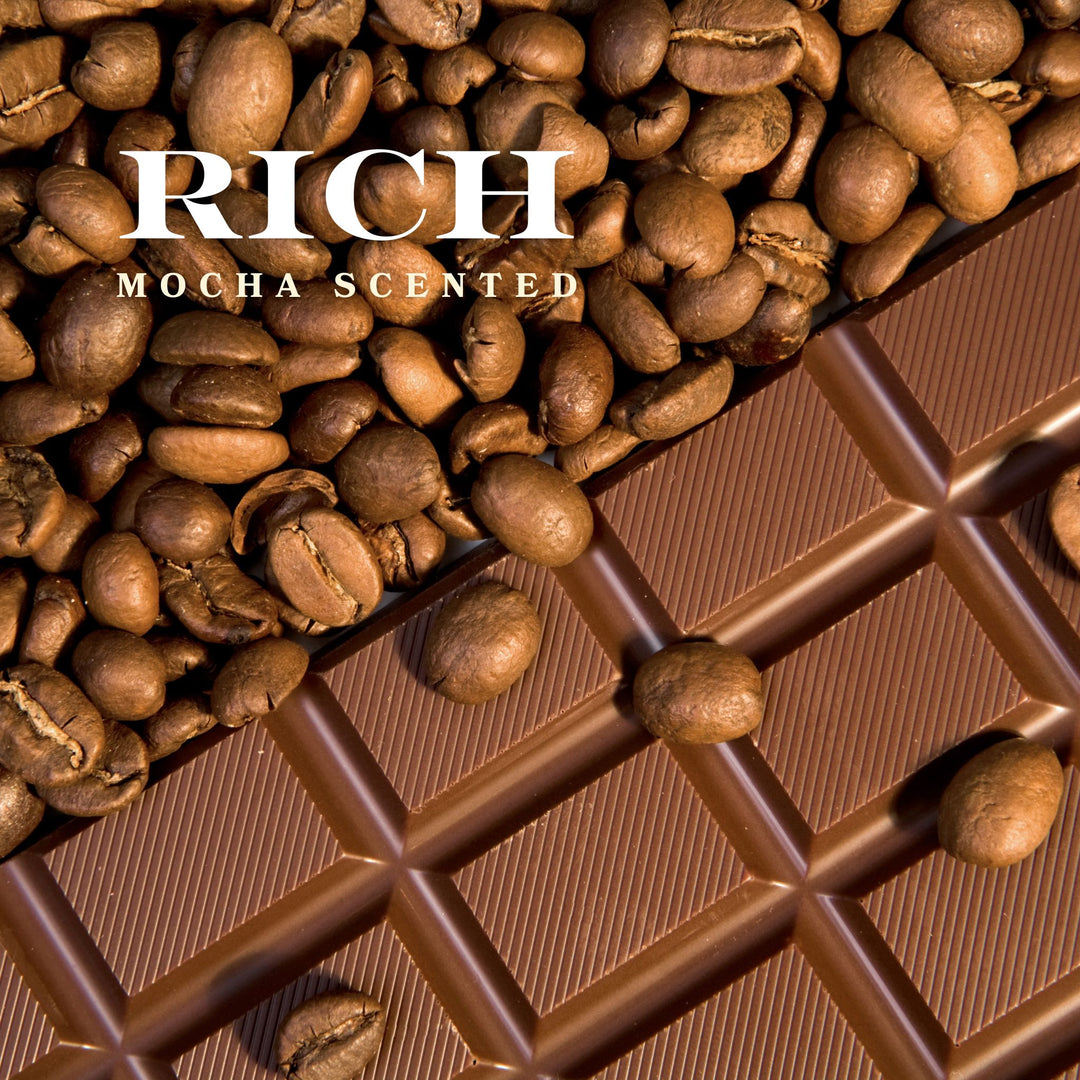Close-up of coffee beans scattered on a bar of chocolate with the text "Rich Mocha Scented" overlaid.