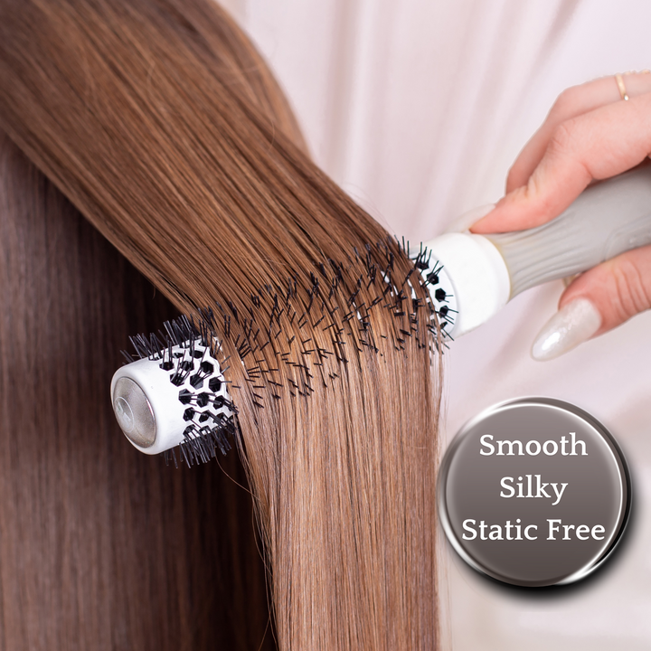 Close-up of a hand brushing long, straight hair with a round brush, highlighting benefits like smooth, silky, and static-free hair.